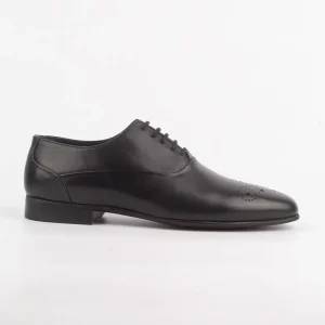 A side view of Calvano Black Formal Shoes featuring intricate brogue detailing on the toe.
