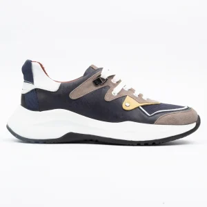 Close-up of Calvano leather sneakers in navy and taupe, showcasing multi-texture design and chunky white sole