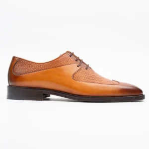 Close-up of a Calvano perforated tan leather shoes for men, showcasing exquisite craftsmanship and rich colour.