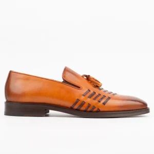 A side view of Calvano tan leather loafers featuring tassel details and unique side stitching